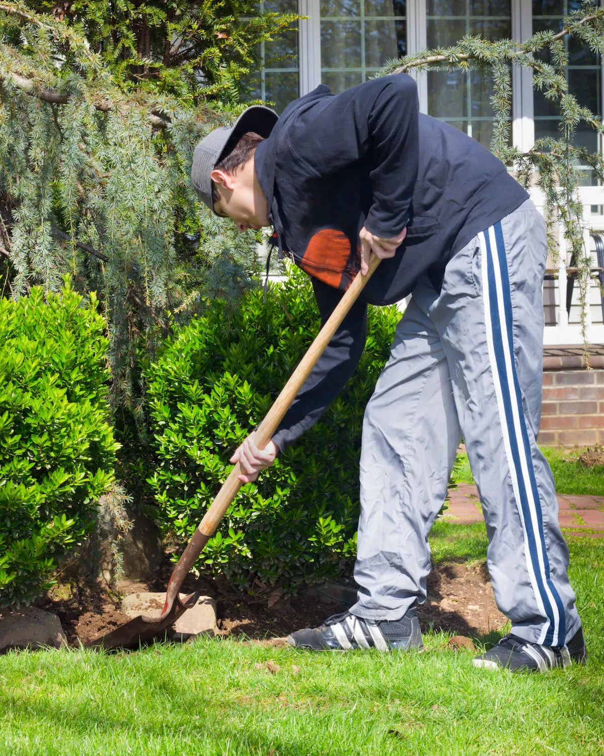 teenage boy doing yard work