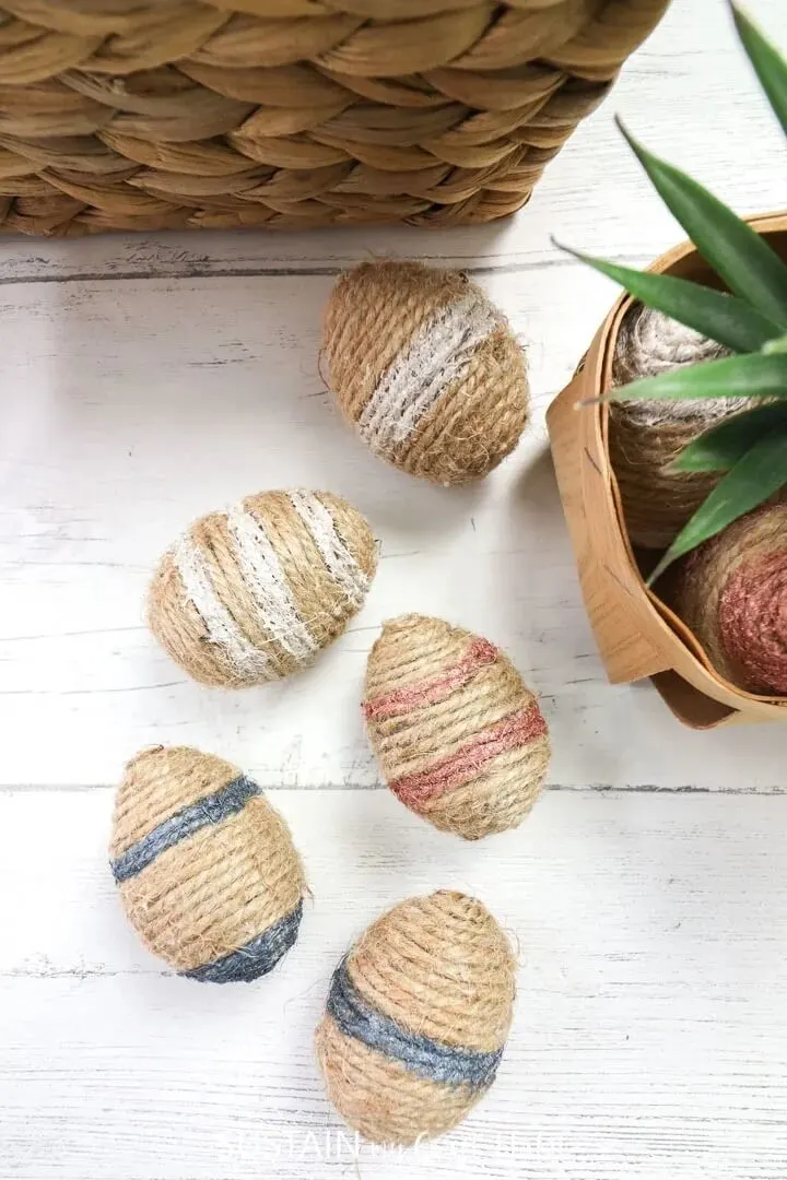 twine wrapped easter eggs on a bench